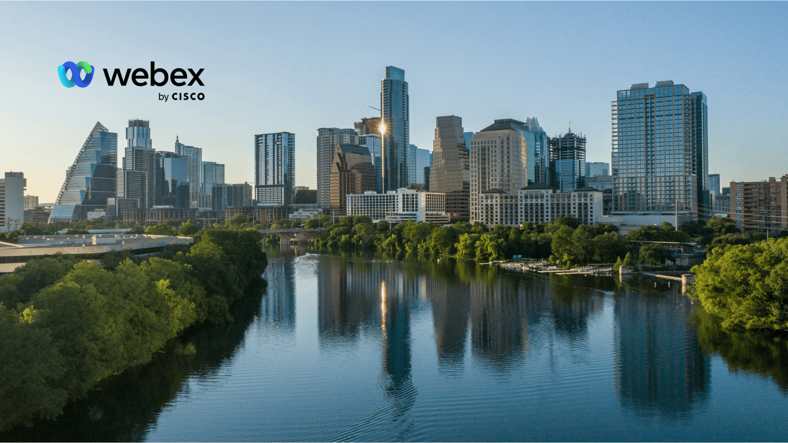 Webex by Cisco logo over the Austin, Texas skyline reflected in Lady Bird Lake, ahead of WebexOne 2026.