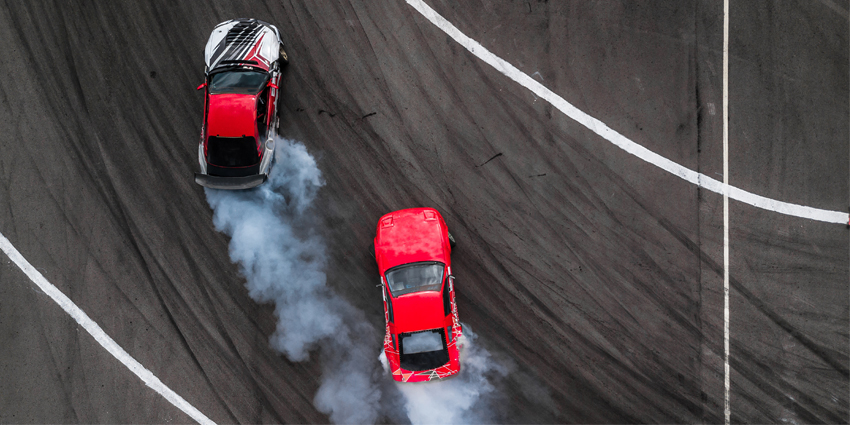 Aerial view two cars drift battle view from above, Activity two cars drift action battle on asphalt race track with abstract smoke.