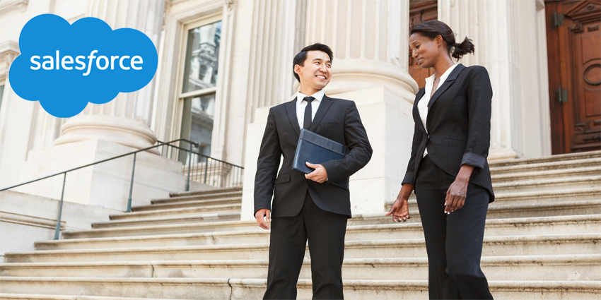 A well dressed man and woman smiling as they as they walk down steps of a courthouse building. Could be business or legal professionals.