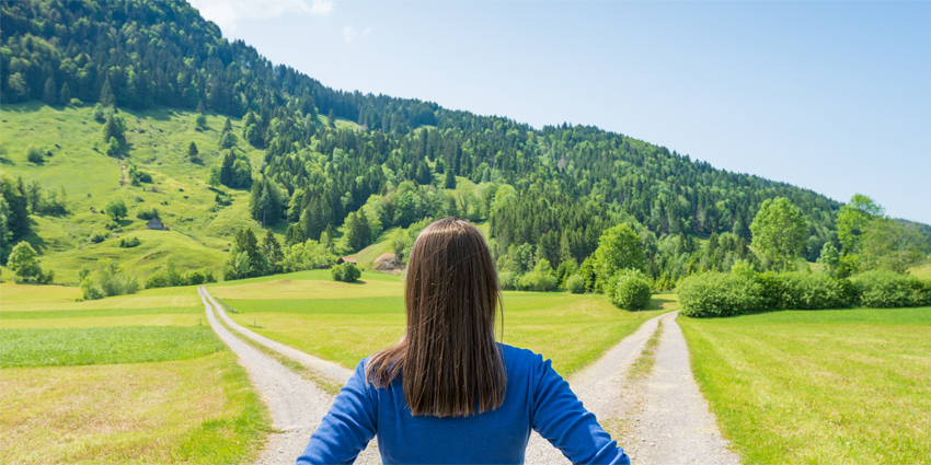 A choice of two ways. Woman at a crossroads.