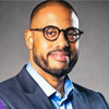A headshot of Thomas John